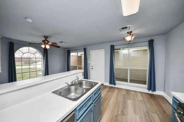 a kitchen with a sink and a large mirror