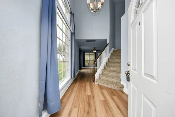 a view of entryway and hall with wooden floor