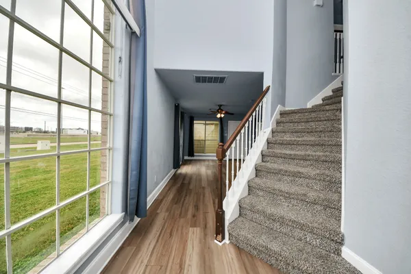 a view of staircase with wooden floor and a window