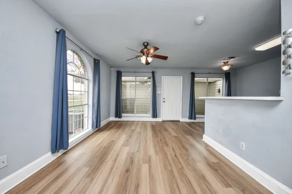 wooden floor in an empty room with a window