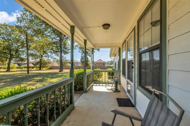 a view of a porch with a table and chairs