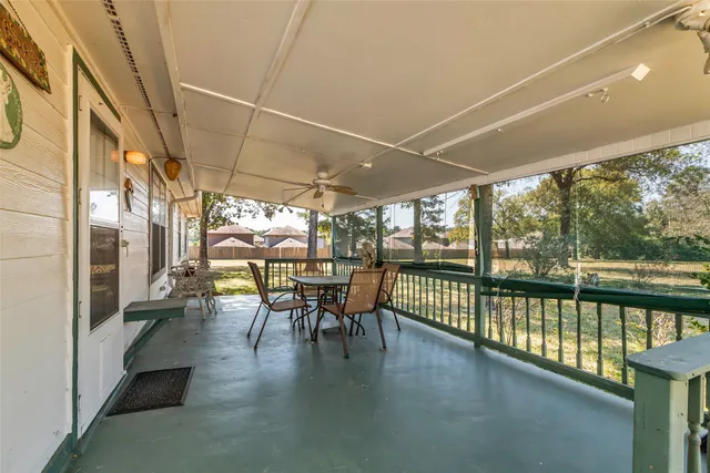 a dining room with furniture water view and a floor to ceiling window