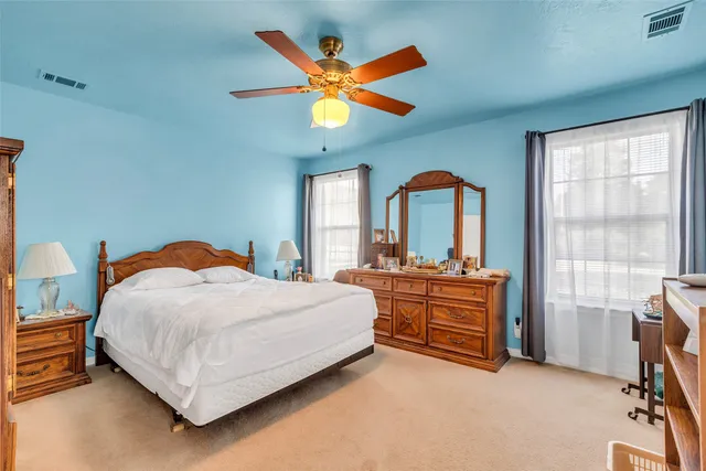 wooden floor & ceiling fan in a room