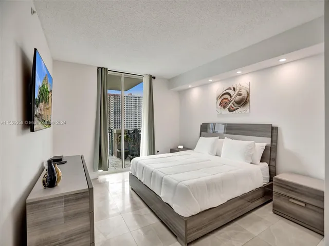 a white toilet sitting next to a bathroom sink and tub