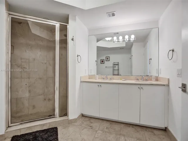 a large bed sitting in a bedroom next to a window