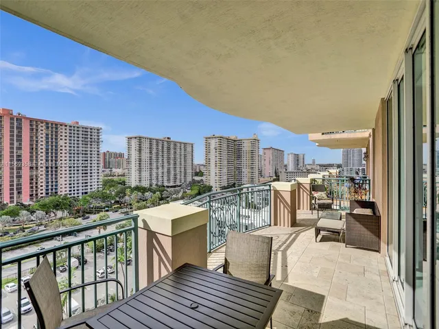 a view of a hallway with wooden floor and a livingroom
