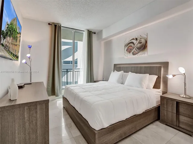 a bedroom with a large bed and a closet