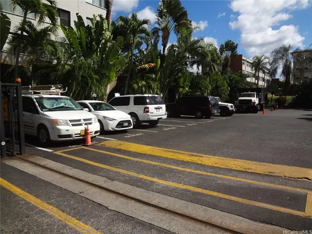 a view of street with parked cars
