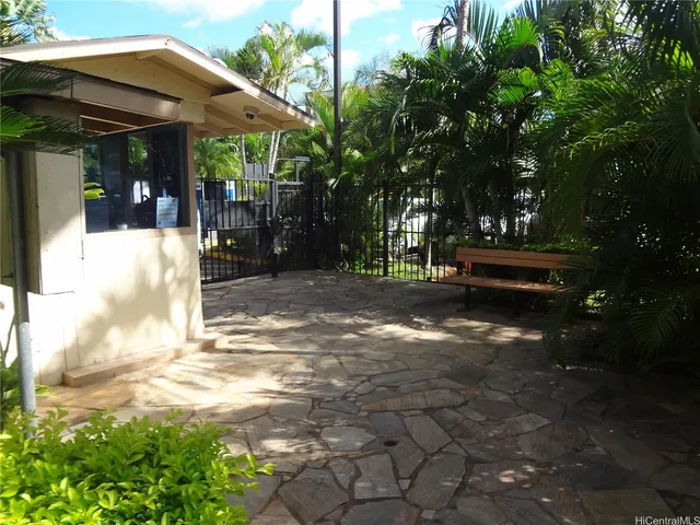 a view of a patio with table and chairs under an umbrella