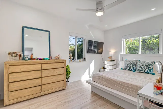 a bedroom with a bed window and a dresser