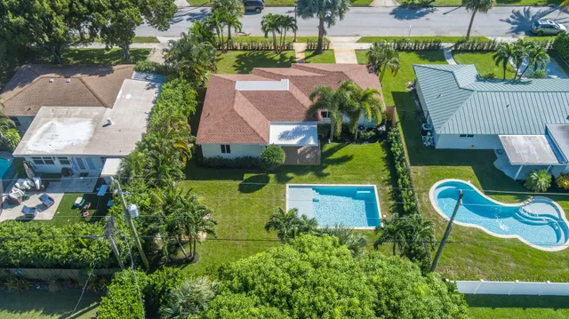 an aerial view of house with swimming pool outdoor seating and yard