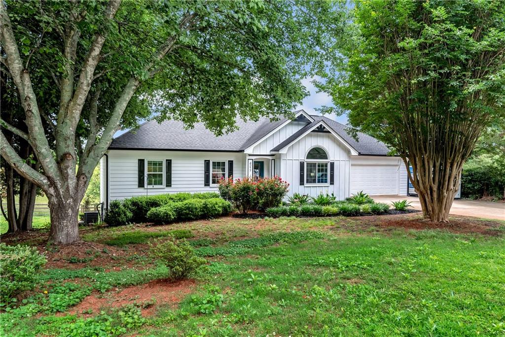 4217 Benefield Road Braselton, GA 30517 - Photo 1 of 1 a front view of a house with a yard and garage