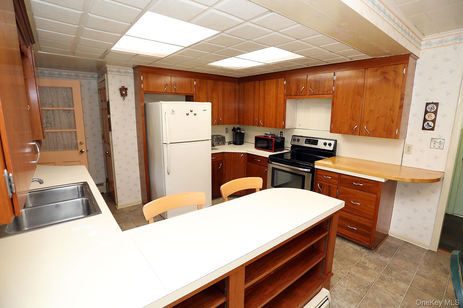 9568 Highway 97 Callicoon, NY 12723 - Photo 6 of 50 a kitchen with a refrigerator a stove and a sink