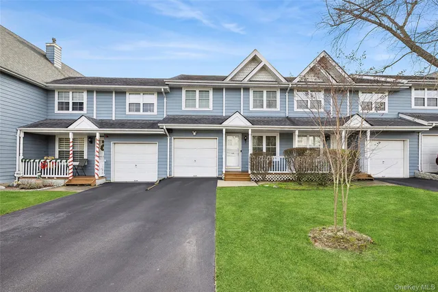 a front view of a residential apartment building with a yard