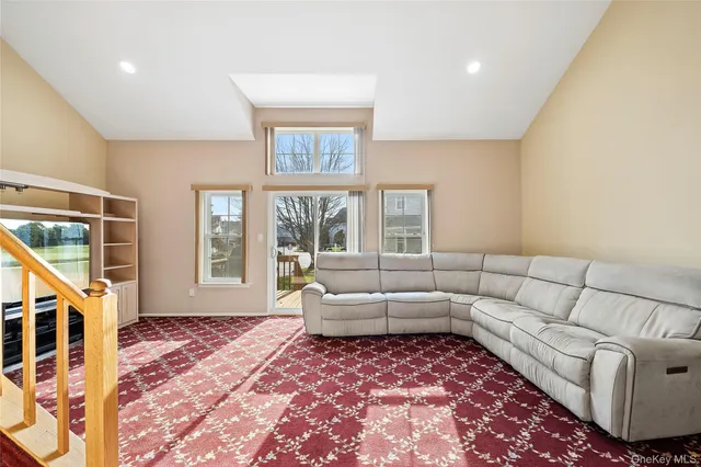 a living room with furniture and a floor to ceiling window