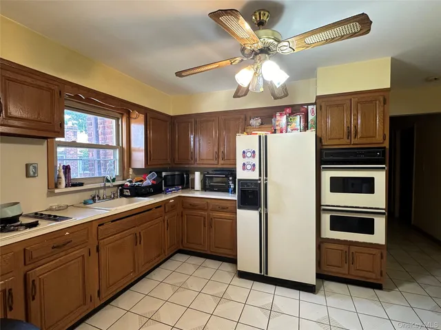 a kitchen with a refrigerator a sink and cabinets