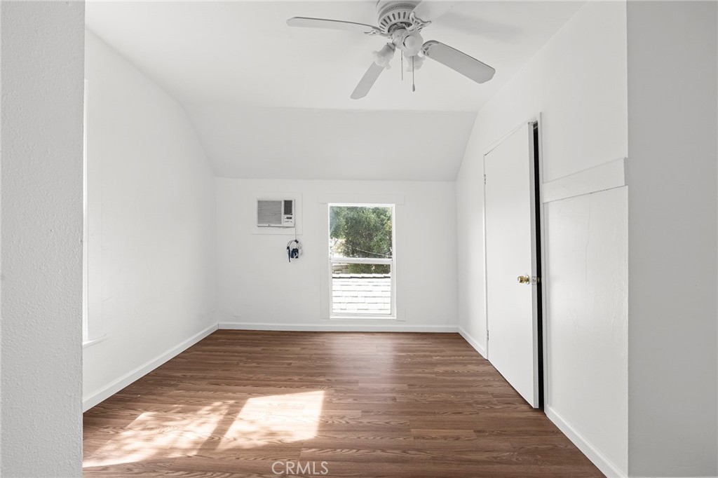 818 6th Street Corning, CA 96021 - Photo 21 of 32 a view of an empty room with wooden floor and a window