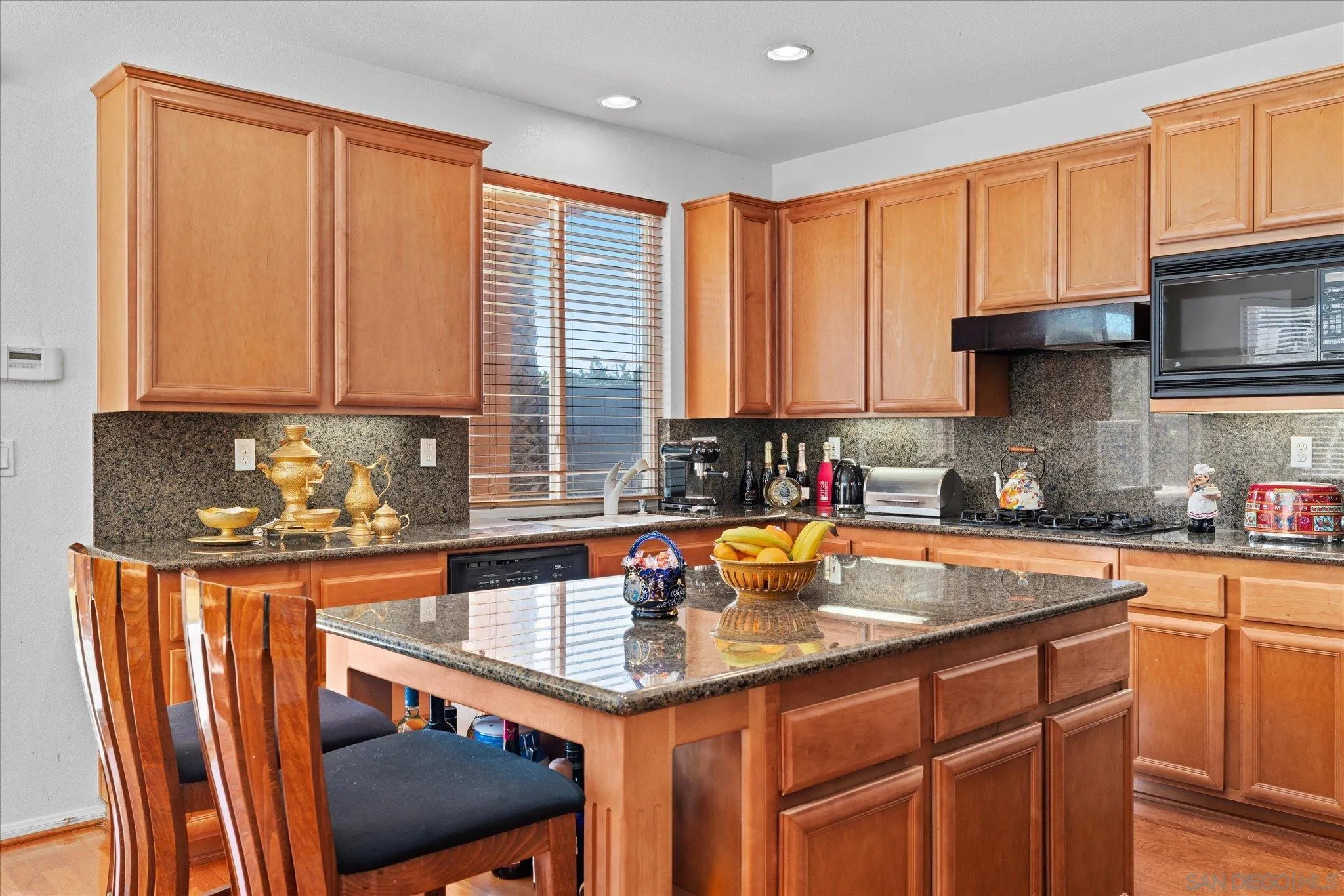 3971 Via Cangrejo San Diego, CA 92130 - Photo 8 of 26 a kitchen with stainless steel appliances granite countertop a sink stove and cabinets
