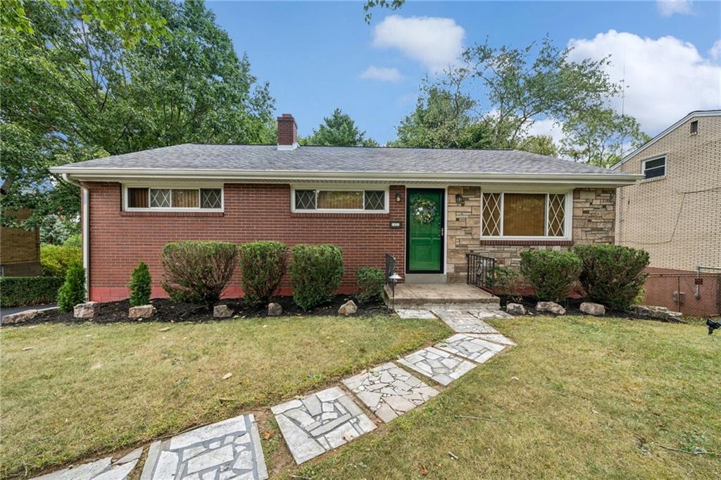 a view of a house with a yard and plants