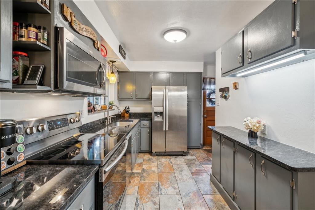 1492 Anderson Road Pittsburgh, PA 15209 - Photo 12 of 46 a kitchen with stainless steel appliances granite countertop a refrigerator a stove and a sink
