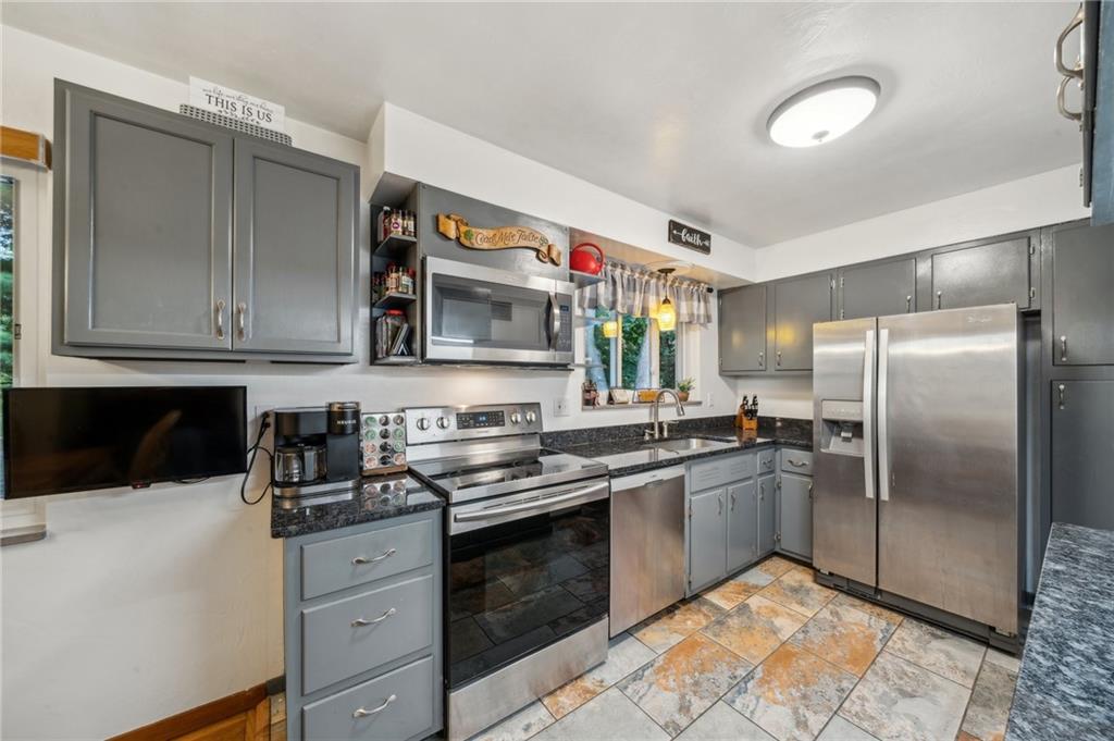 1492 Anderson Road Pittsburgh, PA 15209 - Photo 14 of 46 a kitchen with stainless steel appliances granite countertop a refrigerator and a stove top oven