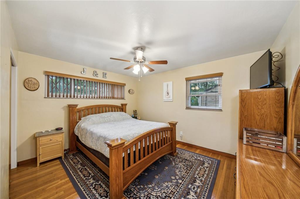 1492 Anderson Road Pittsburgh, PA 15209 - Photo 18 of 46 a bedroom with a bed and wooden floor
