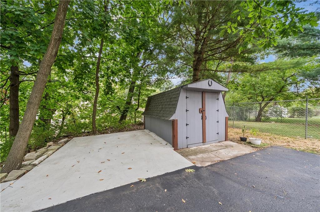 1492 Anderson Road Pittsburgh, PA 15209 - Photo 31 of 46 a backyard of a house with large trees and outdoor seating