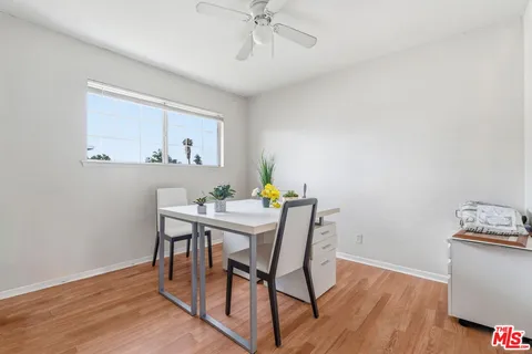 a view of a workspace with furniture and wooden floor