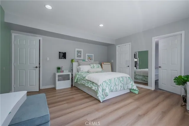 a bedroom with a bed and a potted plant