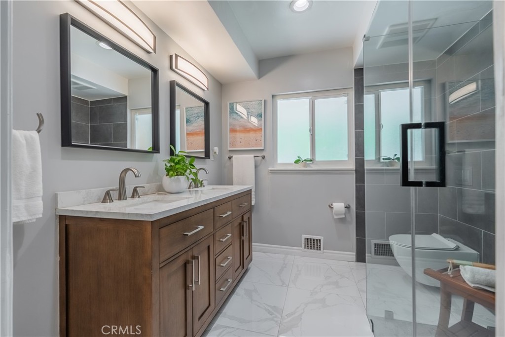 19742 Cameron Avenue Covina, CA 91724 - Photo 16 of 48 a bathroom with a double vanity sink a mirror and a shower