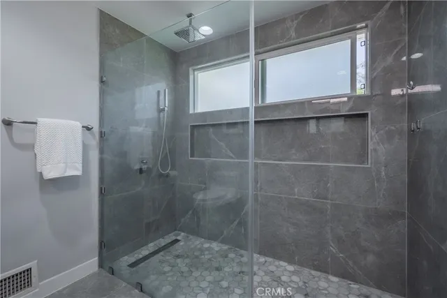 a bathroom with a glass shower door
