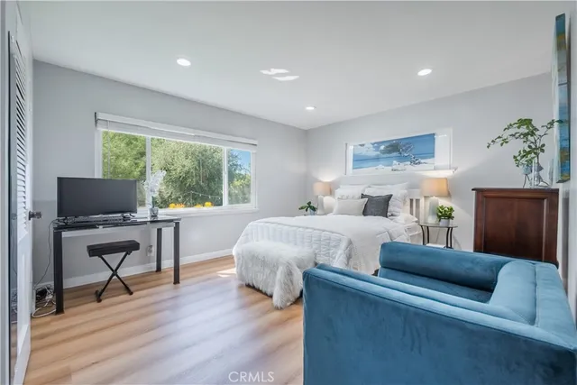 a bed room with bed and a chair