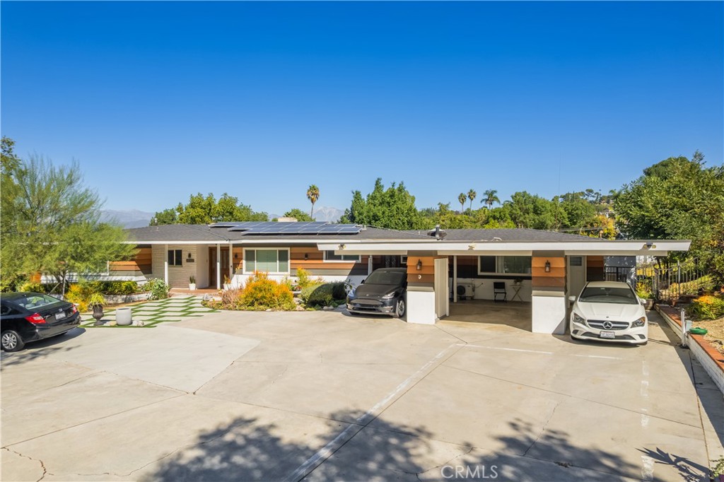 19742 Cameron Avenue Covina, CA 91724 - Photo 2 of 48 a view of a patio with dining table and chairs under an umbrella