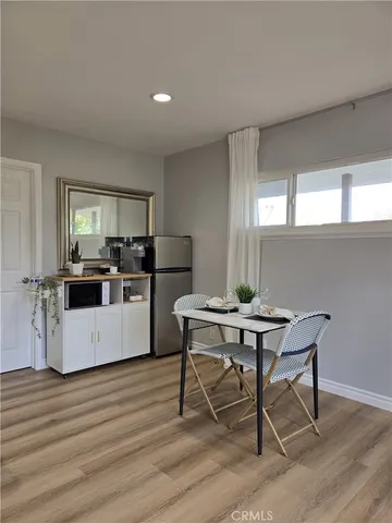 a kitchen with sink a microwave and cabinets