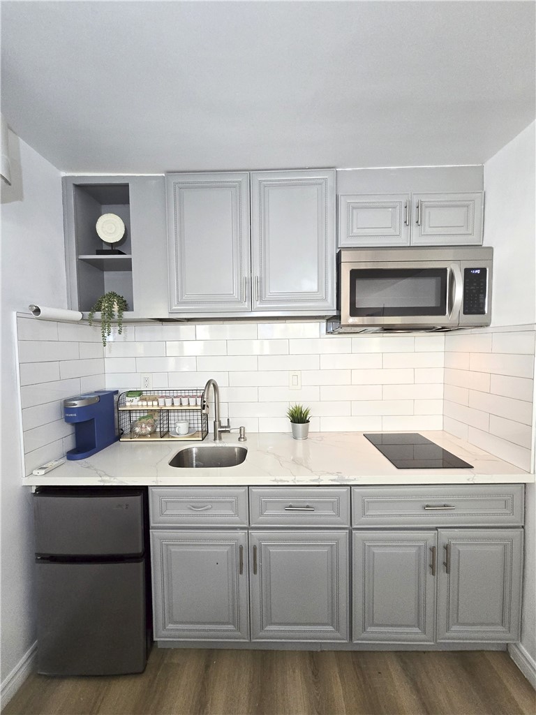 19742 Cameron Avenue Covina, CA 91724 - Photo 26 of 48 a kitchen with sink a microwave and cabinets
