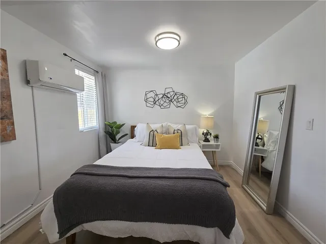 a bedroom with a bed a desk and chair