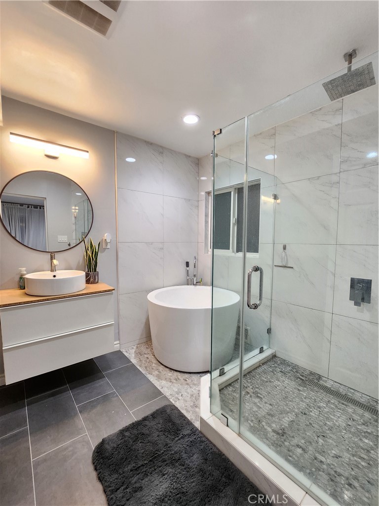 19742 Cameron Avenue Covina, CA 91724 - Photo 34 of 48 a bathroom with a granite countertop sink mirror and bathtub
