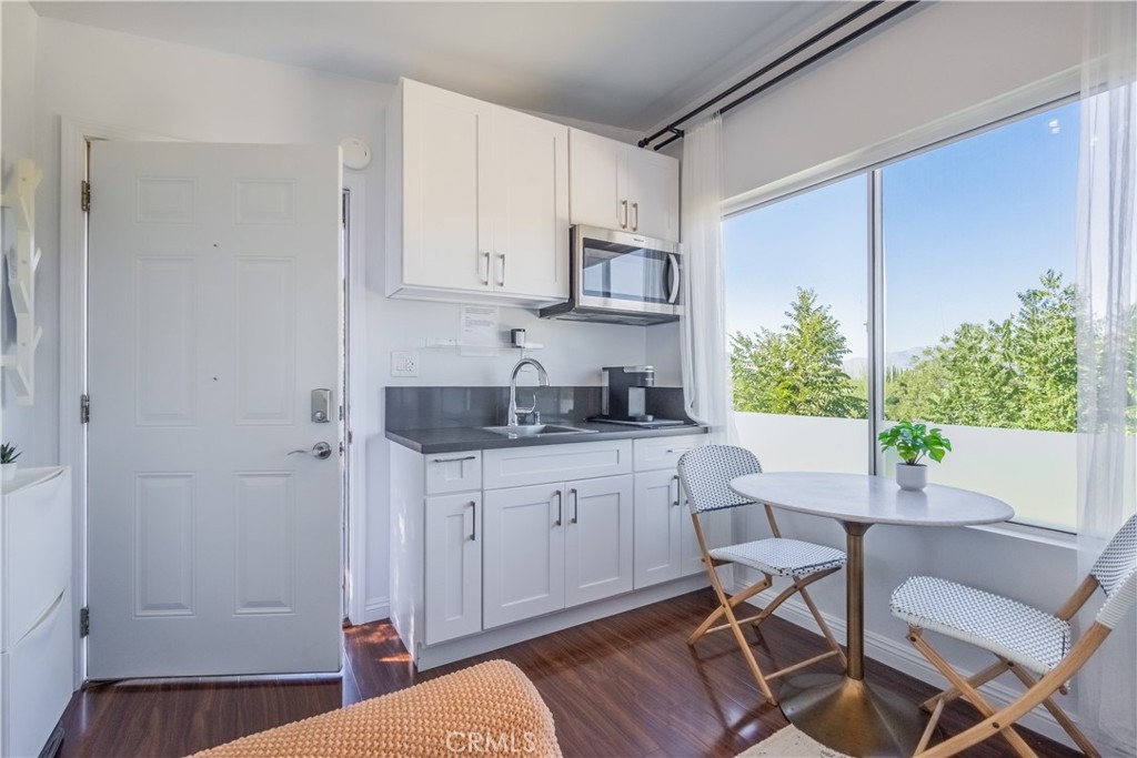 19742 Cameron Avenue Covina, CA 91724 - Photo 40 of 48 a kitchen with stainless steel appliances granite countertop a refrigerator and a white cabinets