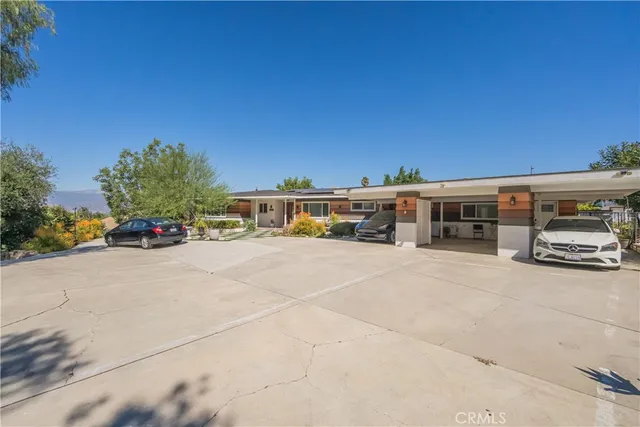 a view of a patio with couches under an umbrella