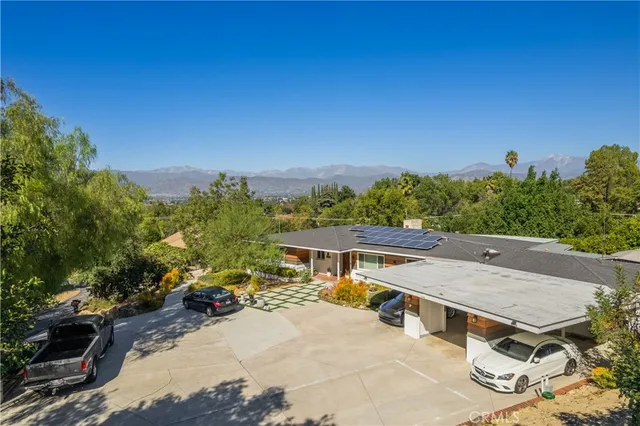 an aerial view of a house with a yard swimming pool