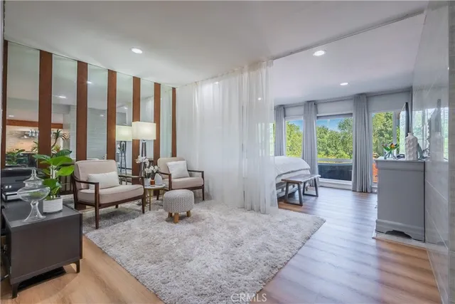 a living room with furniture and large windows