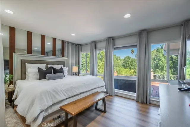 a bedroom with a large bed and a large window