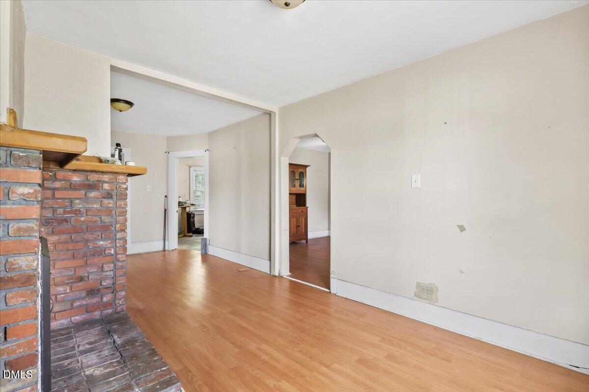 2213 Hunter Hill Road Rocky Mount, NC 27804 - Photo 4 of 11 a view of an empty room with wooden floor and a window
