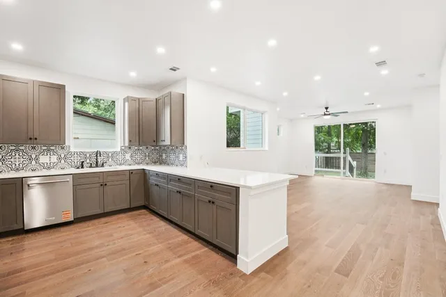 a large kitchen with granite countertop a large counter top and sink
