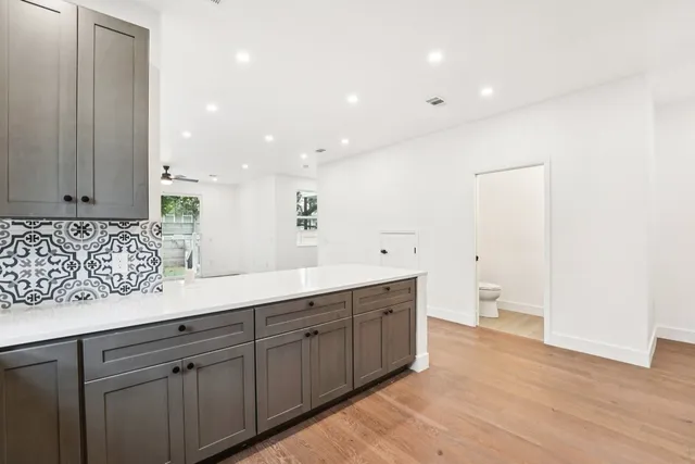 a spacious bathroom with a granite countertop sink and a mirror