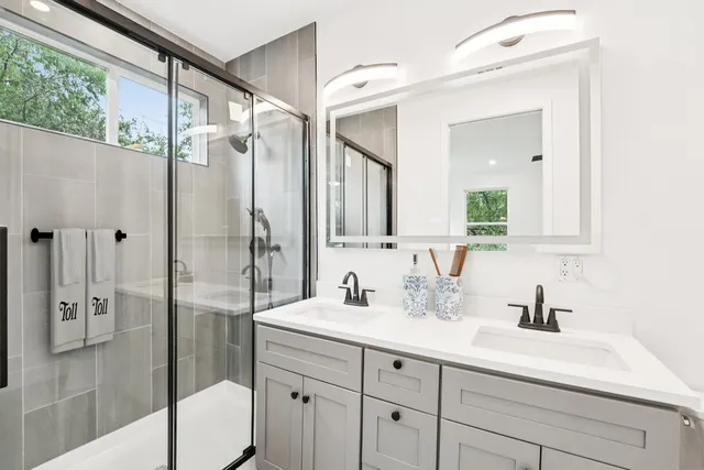 a bedroom with a bed and a potted plant on table