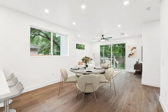 a dining room with furniture and wooden floor