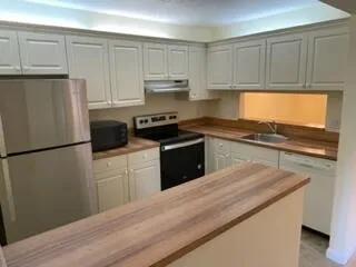 a bathroom with a sink and mirror with toilet