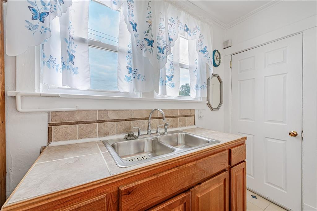 2539 Mahon Street Pittsburgh, PA 15219 - Photo 16 of 24 a close view of a sink and a mirror in a bathroom