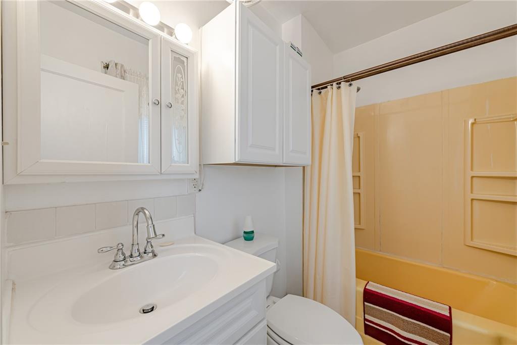 2539 Mahon Street Pittsburgh, PA 15219 - Photo 17 of 24 a bathroom with a sink mirror vanity and toilet